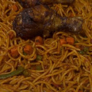 Jollof spaghetti mix plate served with 2 proteins